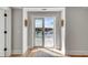 View of a home's balcony, featuring sliding glass doors framed by decorative sconces at 34 Waterway Island Dr, Isle of Palms, SC 29451