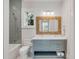 Stylish bathroom featuring a bathtub, shower, blue vanity with double sinks, and a textured mirror at 34 Waterway Island Dr, Isle of Palms, SC 29451