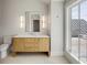 Bathroom featuring a wooden vanity with white countertop, modern light fixtures and a large window at 34 Waterway Island Dr, Isle of Palms, SC 29451
