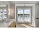 Bright bathroom with a long vanity, double sinks, a large mirror, and a window view to the outside at 34 Waterway Island Dr, Isle of Palms, SC 29451