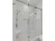 Modern bathroom with glass-enclosed shower, bench, and elegant mosaic tile flooring at 34 Waterway Island Dr, Isle of Palms, SC 29451