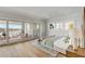 Bright bedroom with a private balcony, marina views, light hardwood flooring, and a comfortable bed at 34 Waterway Island Dr, Isle of Palms, SC 29451