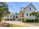 Luxurious three-story home with an attached garage and large driveway at 34 Waterway Island Dr, Isle of Palms, SC 29451