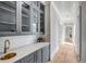 Hallway featuring custom cabinetry, quartz countertops, hardwood floors and plenty of natural light at 34 Waterway Island Dr, Isle of Palms, SC 29451