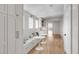 Hallway with bench seating, wall cabinet storage, and hardwood floors offers style and function at 34 Waterway Island Dr, Isle of Palms, SC 29451