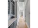 Hallway features custom cabinetry, quartz countertops, and wood floors leading to sun-filled rooms at 34 Waterway Island Dr, Isle of Palms, SC 29451