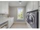 Well-equipped laundry room with new appliances, ample storage, and natural light at 34 Waterway Island Dr, Isle of Palms, SC 29451
