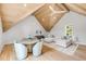 Bright living room boasts vaulted ceilings, exposed wood beams, hardwood floors, and a stylish round dining table at 34 Waterway Island Dr, Isle of Palms, SC 29451