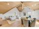 Spacious living room featuring vaulted ceilings, wood beams, light hardwood flooring, and a comfortable seating area at 34 Waterway Island Dr, Isle of Palms, SC 29451