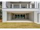 This beautiful home includes a covered outdoor patio and sliding glass doors at 34 Waterway Island Dr, Isle of Palms, SC 29451