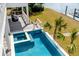 Backyard swimming pool and lounge area with a view of the waterway and palm trees at 34 Waterway Island Dr, Isle of Palms, SC 29451