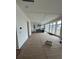 Spacious living room with white trim, large windows, and a kitchen with a center island in the background at 1560 John Fenwick Ln, Johns Island, SC 29455
