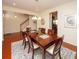 Formal dining room with hardwood floors, a large wooden table, and access to kitchen at 8897 Cat Tail Pond Rd, Summerville, SC 29485