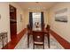 Formal dining room featuring hardwood floors, a wooden table, and dark blue curtains at 8897 Cat Tail Pond Rd, Summerville, SC 29485