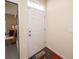 Front entry with white door, wood flooring, and view into adjacent room at 8897 Cat Tail Pond Rd, Summerville, SC 29485
