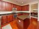 Kitchen with an island, granite countertops, and dark wood cabinets at 8897 Cat Tail Pond Rd, Summerville, SC 29485