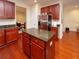 Kitchen features dark wood cabinets, granite countertops, and stainless steel appliances at 8897 Cat Tail Pond Rd, Summerville, SC 29485
