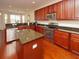 Spacious kitchen with dark wood cabinets, granite countertops, and stainless steel appliances at 8897 Cat Tail Pond Rd, Summerville, SC 29485