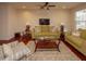 Living room with hardwood floors, olive couches, and a ceiling fan at 8897 Cat Tail Pond Rd, Summerville, SC 29485