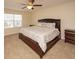 King-size bedroom with dark wood furniture and ceiling fan at 8897 Cat Tail Pond Rd, Summerville, SC 29485
