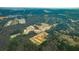 An aerial view of a Primary-planned community shows new home construction nestled among green trees and ponds at 132 Morning View Way, Moncks Corner, SC 29461