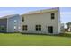 Backyard of a white house with a large lawn and blue house nearby at 132 Morning View Way, Moncks Corner, SC 29461