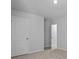 An empty bedroom featuring a light colored carpet, base trim, neutral wall paint and two doors at 132 Morning View Way, Moncks Corner, SC 29461