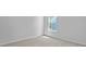 An empty bedroom featuring a light colored carpet and base trim, window and a neutral wall paint at 132 Morning View Way, Moncks Corner, SC 29461