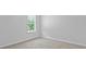 An empty bedroom featuring a light colored carpet and base trim, window and a neutral wall paint at 132 Morning View Way, Moncks Corner, SC 29461