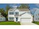 Two-story white house with blue shutters, two-car garage, and landscaped lawn at 132 Morning View Way, Moncks Corner, SC 29461