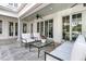 Covered patio showcasing a seating area with comfortable furniture, ceiling fans, and outdoor access at 143 Island Park Dr, Charleston, SC 29492