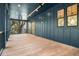 Large outdoor porch with wood floors and dark blue wood paneled walls and ceiling with great light at 615 Pompano St, Edisto Island, SC 29438