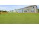 Exterior rear view of multiple homes in a neighborhood showcasing expansive lawns and varied siding colors at 159 Morning View Way, Moncks Corner, SC 29461