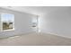 A bright bedroom with two windows that look out onto green space and a light and neutral carpet at 159 Morning View Way, Moncks Corner, SC 29461