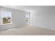A bright bedroom with two windows that look out onto green space and a light and neutral carpet at 159 Morning View Way, Moncks Corner, SC 29461