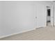 A bedroom featuring neutral carpet, bright white walls, and a door leading to the ensuite bathroom at 159 Morning View Way, Moncks Corner, SC 29461