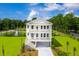 Two-story home with a front porch, driveway, and landscaped lawn at 1636 Siloh St # 478, Mount Pleasant, SC 29466