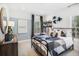 Bright bedroom with a metal bed frame, dresser, and large windows at 1636 Siloh St # 478, Mount Pleasant, SC 29466