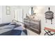 Bright bedroom featuring a wood dresser and geometric quilt at 1636 Siloh St # 478, Mount Pleasant, SC 29466