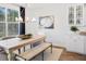 Light and airy dining room with a farmhouse table and bench at 1636 Siloh St # 478, Mount Pleasant, SC 29466