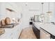 White kitchen with gas cooktop, quartz countertops, and herringbone backsplash at 1636 Siloh St # 478, Mount Pleasant, SC 29466