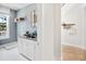 Laundry room with white cabinets, a sink, and built-in shelving at 1636 Siloh St # 478, Mount Pleasant, SC 29466