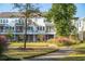 Rear view of townhomes with grassy yard and walkway at 1636 Siloh St # 478, Mount Pleasant, SC 29466