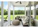 Relaxing screened porch with comfortable seating and view of backyard at 229 Claret Cup Way, Charleston, SC 29414