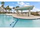 Beautiful community pool with a poolside bar, lounge chairs, and palm trees at 252 Cooper River Dr, Mount Pleasant, SC 29464