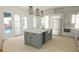 Bright kitchen features an island, stainless steel appliances, and white shaker cabinets at 35 W 9Th Street Ext, Folly Beach, SC 29439