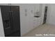 Laundry room with white cabinets, a sink, and a black refrigerator at 35 W 9Th Street Ext, Folly Beach, SC 29439