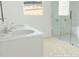 Primary bathroom with double vanity, large shower and soaking tub at 35 W 9Th Street Ext, Folly Beach, SC 29439