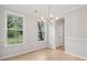 Bright dining room features hardwood floors, chandelier, and large windows at 135 Cantona Dr, Summerville, SC 29483