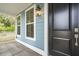 Side view of front porch with black door and white railings at 135 Cantona Dr, Summerville, SC 29483